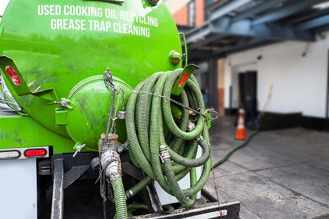 a professional service truck pumping a grease trap in Ashippun WI